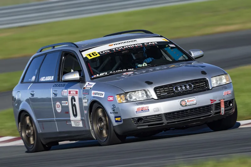 Close-up of silver Audi A4 Avant #6 cornering on track