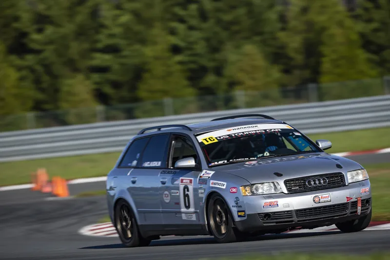 Silver Audi A4 Avant #6 leaning into a corner beside the curbing